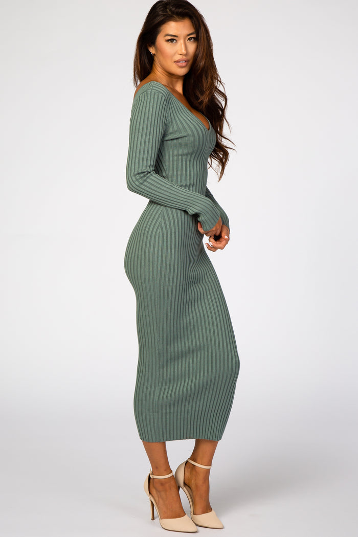 woman wearing a fitted green ribbed long sleeve midi dress and nude heels