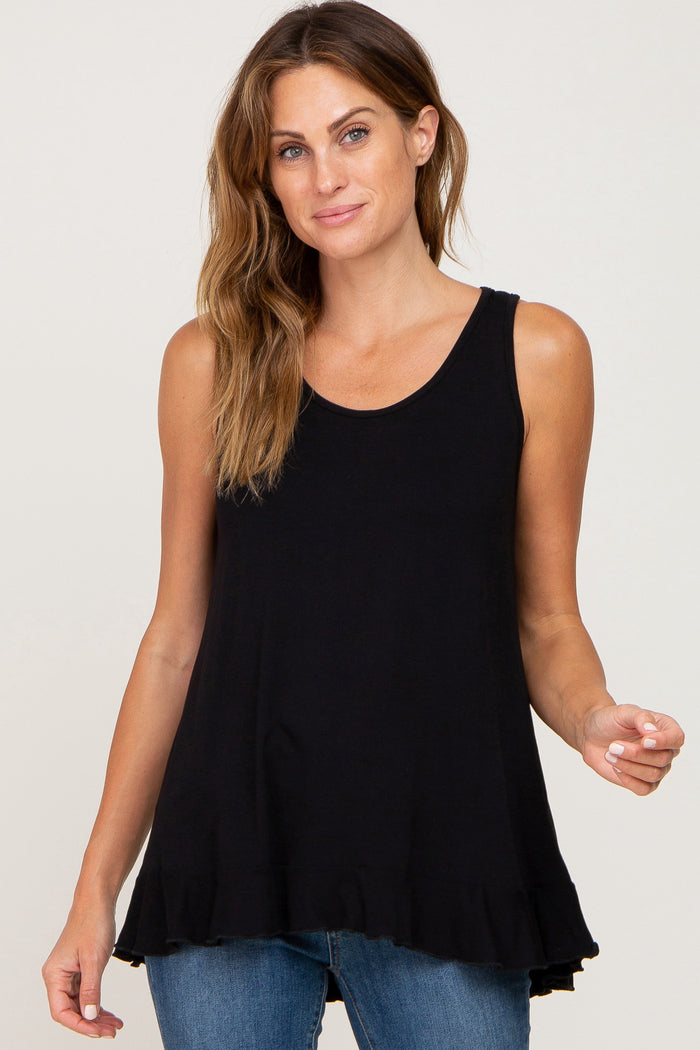 woman wearing a black sleeveless ruffle hem maternity tank top and blue jeans