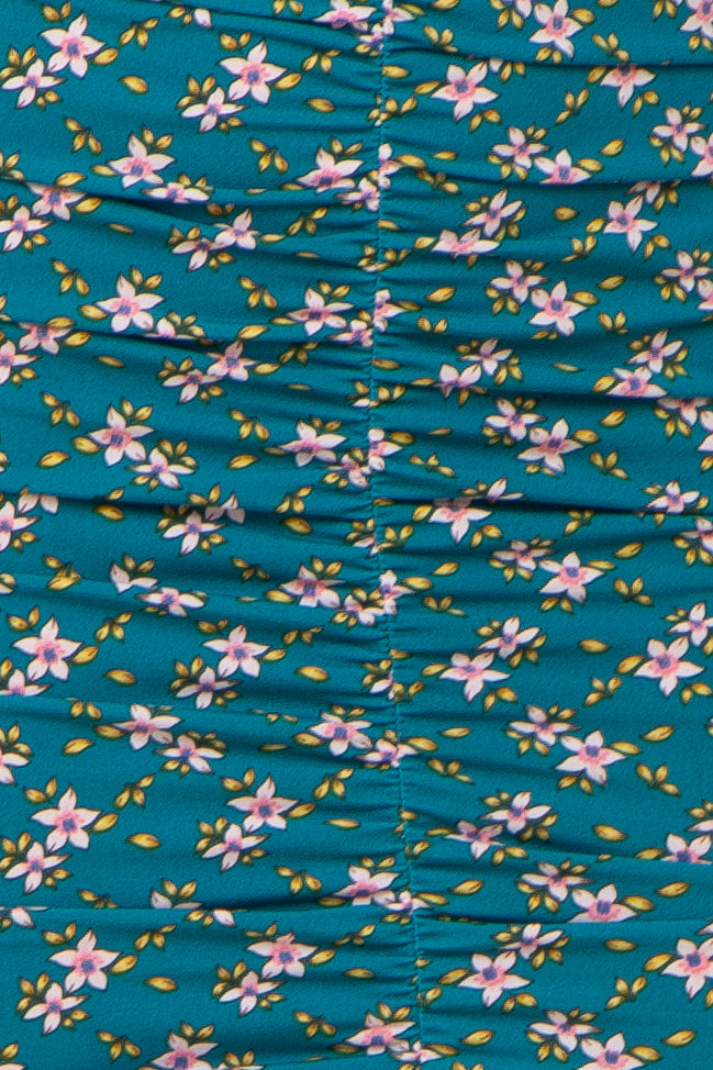 teal floral print dress with gathered detailing and small pink flowers