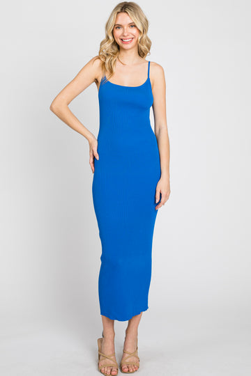 woman wearing a fitted blue ribbed midi dress with thin straps and a form-fitting silhouette