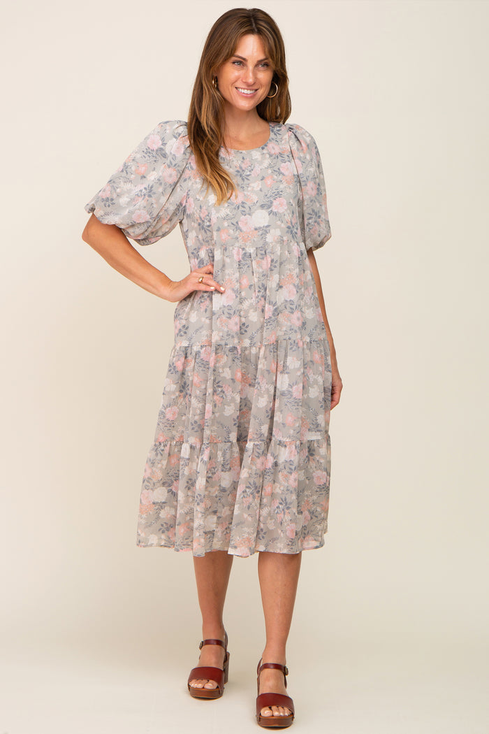woman wearing a grey floral tiered midi dress with puff sleeves and brown platform sandals
